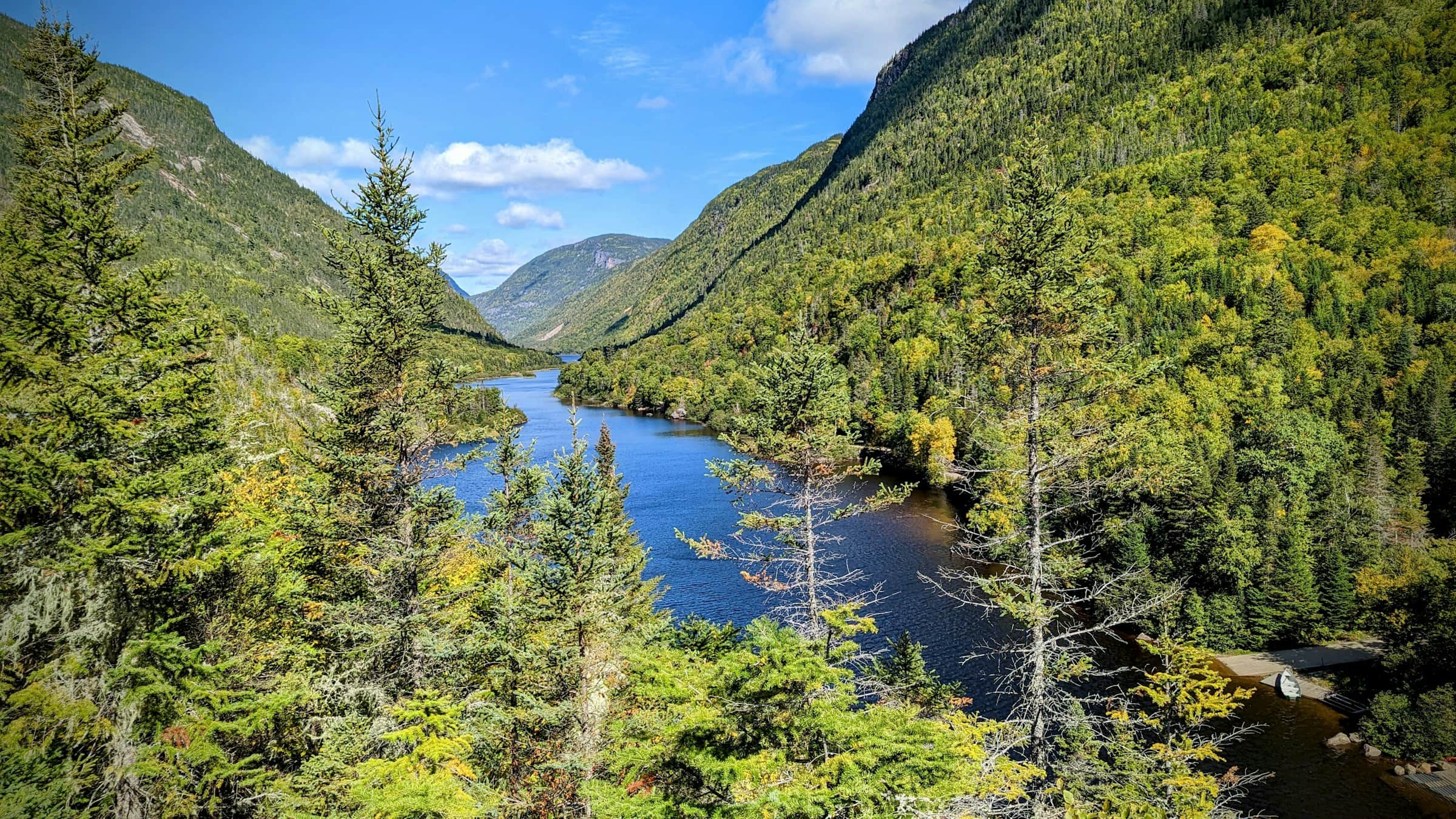 A river winding through a forested glacial valley in the Charlevoix hills, La Malbaie, Quebec