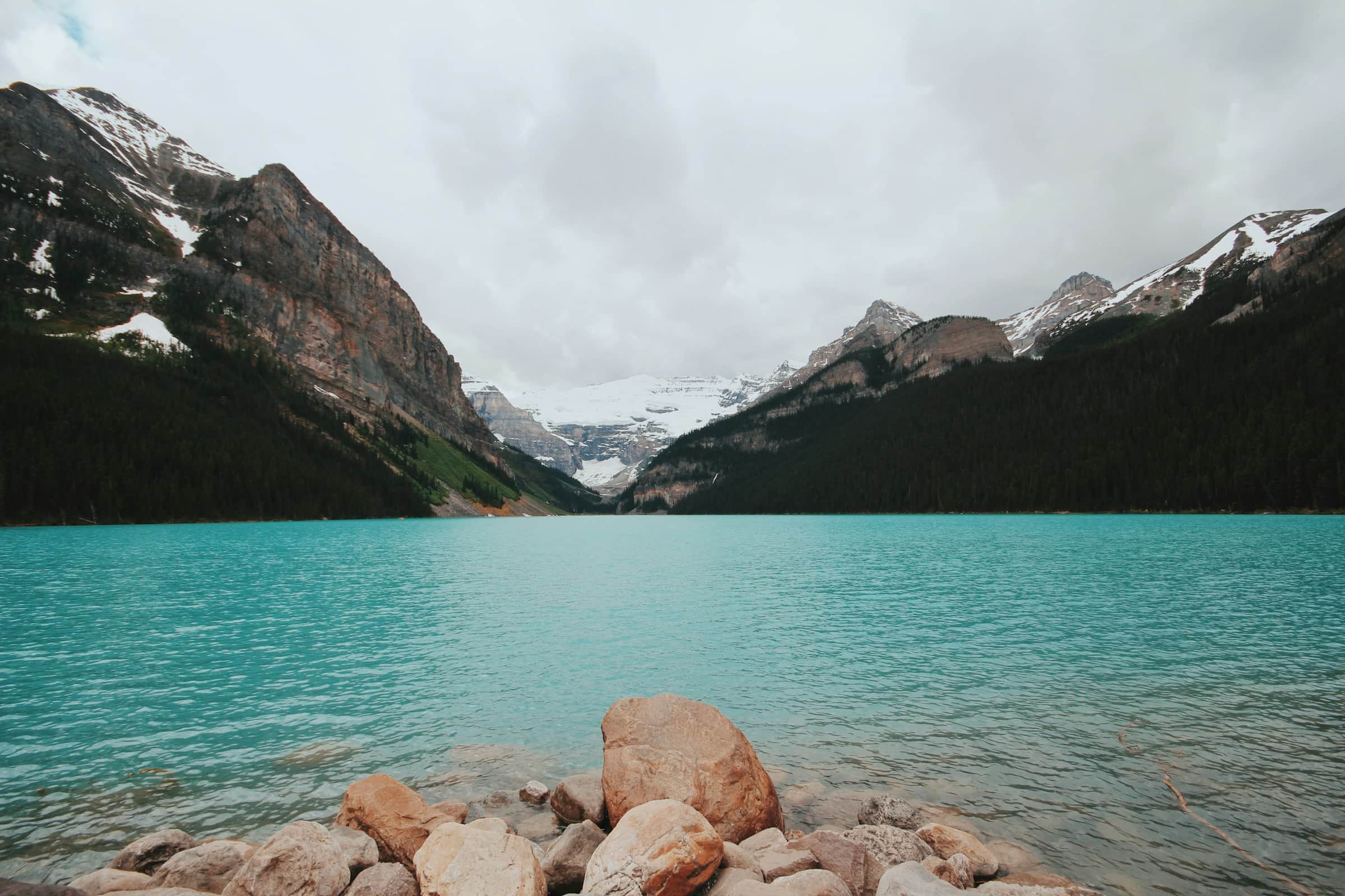 The turquoise glacial water of Lake Louise below Victoria Glacier and snow-capped peaks, Alberta